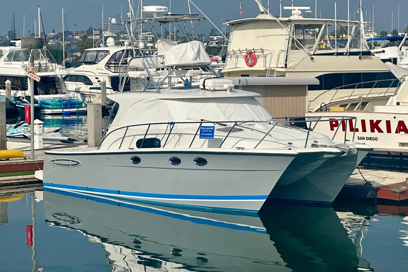 The Image of 2006 Glacier Bay 3480 Ocean Runner catamaran docked in marina, surrounded by other boats. - 0