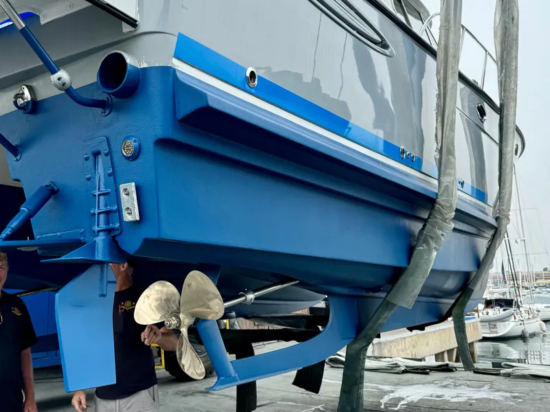 Slide: The Image of 2006 Glacier Bay 3480 Ocean Runner boat in dry dock, showcasing blue hull and propeller. - 10