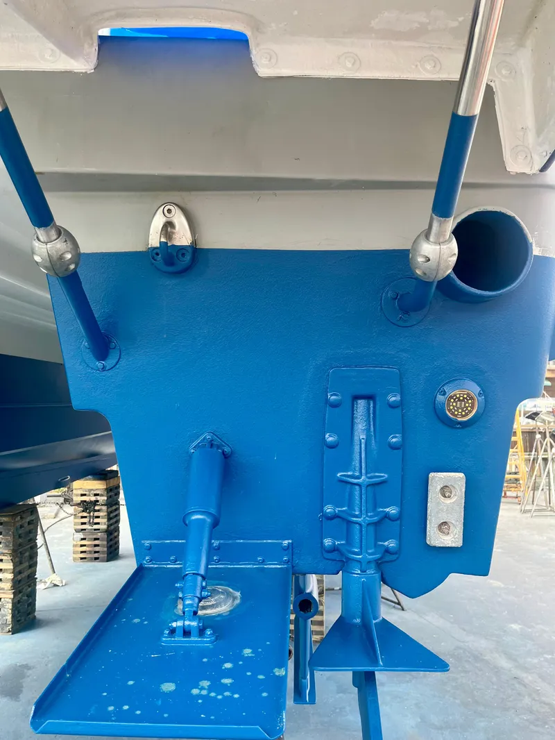 Slide: The Image of Close-up of a 2006 Glacier Bay 3480 Ocean Runner boat's blue-painted stern details. - 12