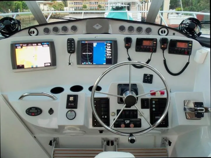 Slide: The Image of Helm of 2006 Glacier Bay 3480 Ocean Runner with navigation screens and controls. - 22
