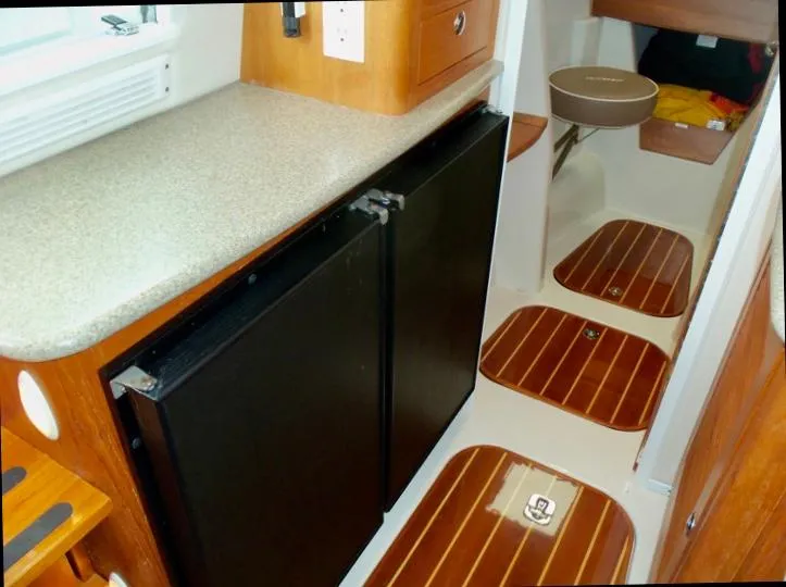 Slide: The Image of Interior of 2006 Glacier Bay 3480 Ocean Runner with wood flooring and compact kitchen area. - 28