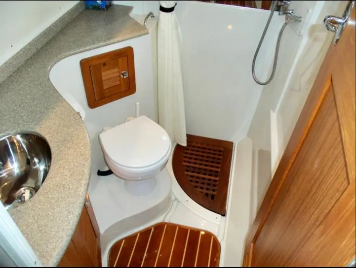 Slide: The Image of 2006 Glacier Bay 3480 Ocean Runner boat bathroom with shower, toilet, and wooden flooring. - 29