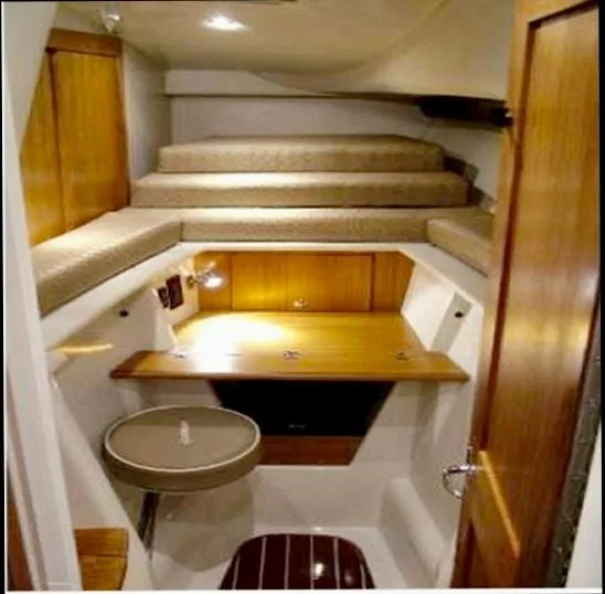 Slide: The Image of 2006 Glacier Bay 3480 Ocean Runner cabin interior with wooden finishes and seating area. - 31