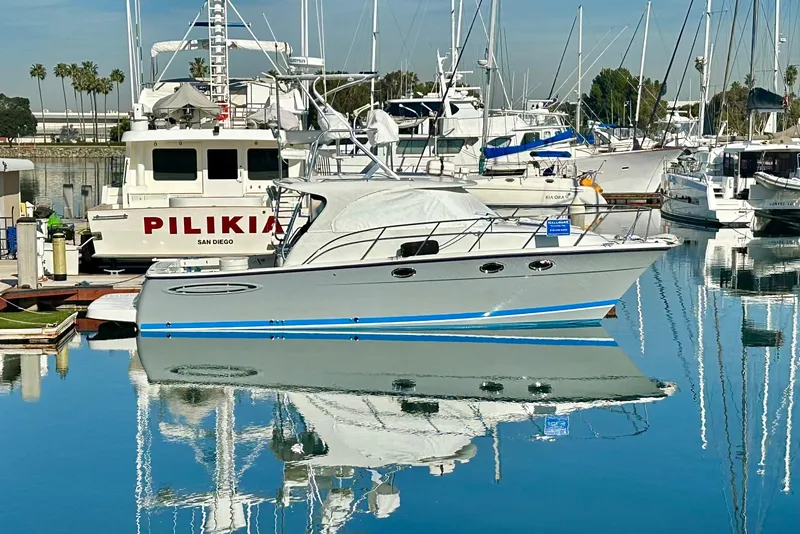Slide: The Image of 2006 Glacier Bay 3480 Ocean Runner boat docked in a marina, reflecting on calm water. - 8
