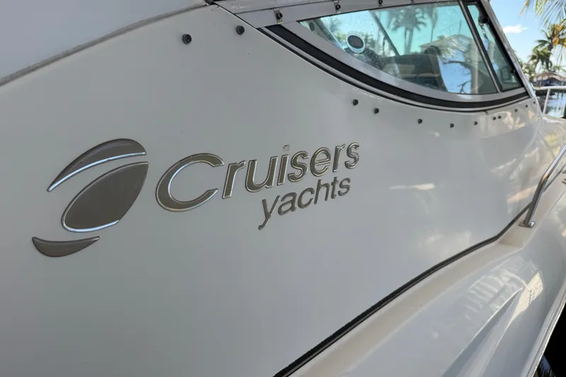 Slide: The Image of 2003 Cruisers Yachts 3075 Express, side view with logo and window detail. - 11