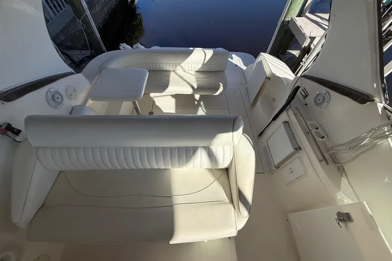 Slide: The Image of 2003 Cruisers Yachts 3075 Express interior with white seating and table. - 12