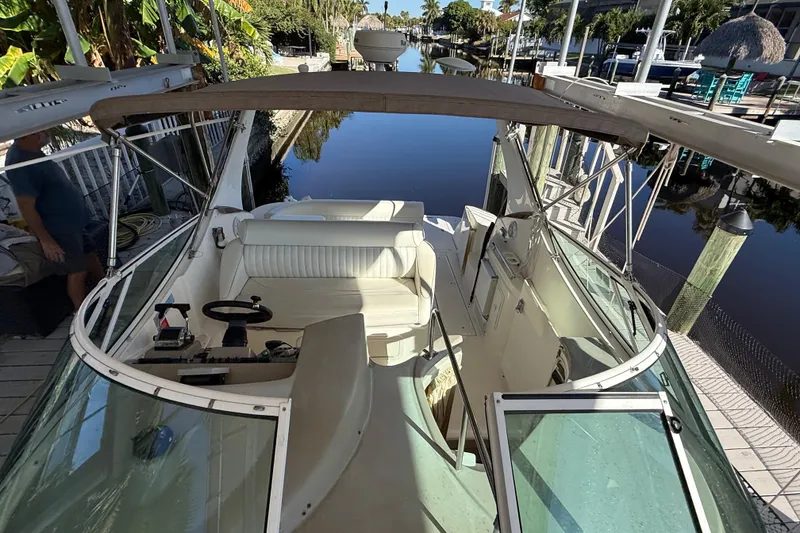 Slide: The Image of 2003 Cruisers Yachts 3075 Express docked by a serene canal. - 14