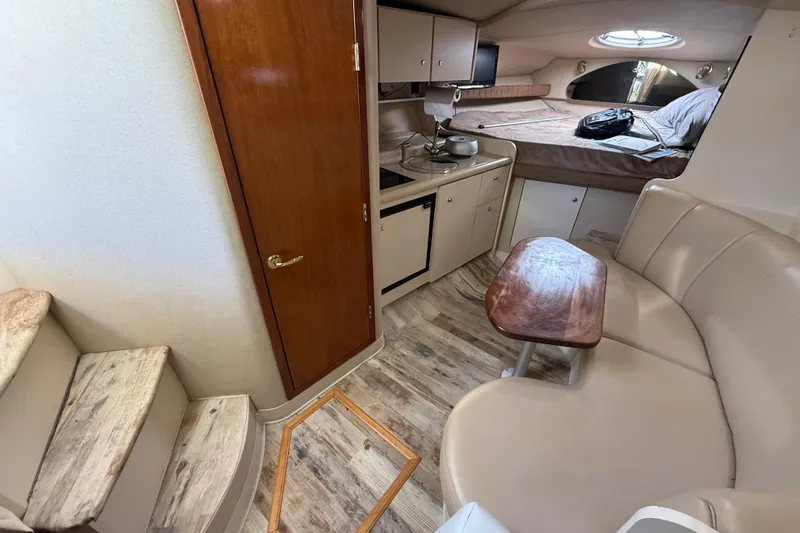 Slide: The Image of Interior of 2003 Cruisers Yachts 3075 Express, featuring kitchenette, seating, and sleeping area. - 18