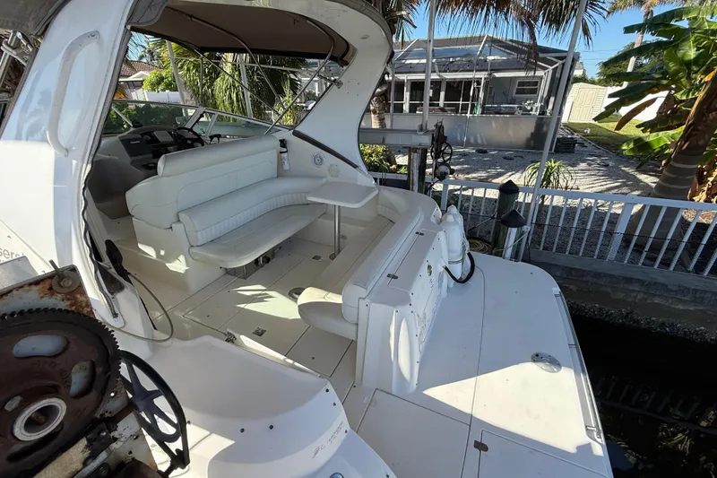 Slide: The Image of 2003 Cruisers Yachts 3075 Express boat interior with white seating and helm. - 7