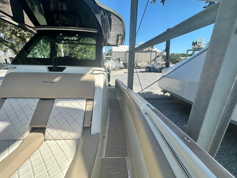 Slide: The Image of 2024 Chris-Craft Catalina 30 boat interior with beige and white diamond-stitched seating. - 16