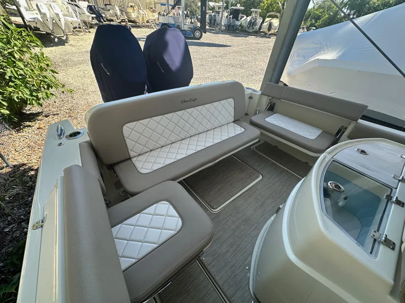 Slide: The Image of 2024 Chris-Craft Catalina 30 interior seating area with white and beige upholstery. - 7