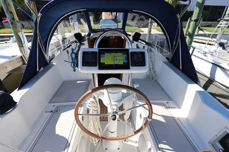 Slide: The Image of Cockpit of 1995 Nonsuch 260 sailboat with navigation equipment and wooden steering wheel. - 14