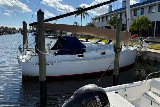 Slide: The Image of Sailboat docked in marina, 1995 Nonsuch 260 model, sunny day with palm trees. - 2