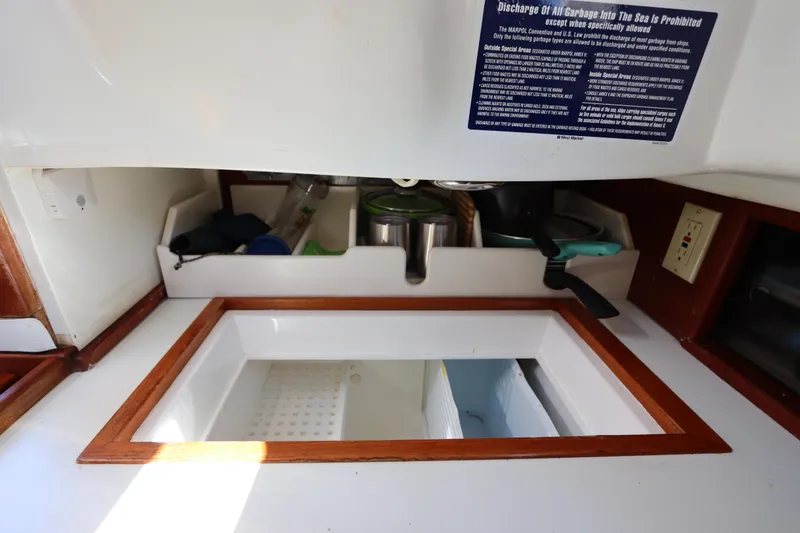 Slide: The Image of Interior of 1995 Nonsuch 260 sailboat galley with storage and sink area. - 24