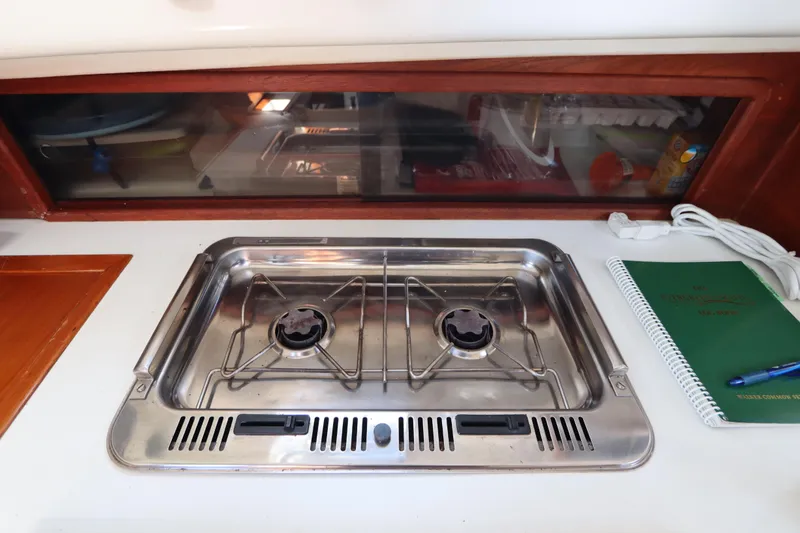Slide: The Image of Stainless steel stove in 1995 Nonsuch 260 boat kitchen with window and notebook. - 25
