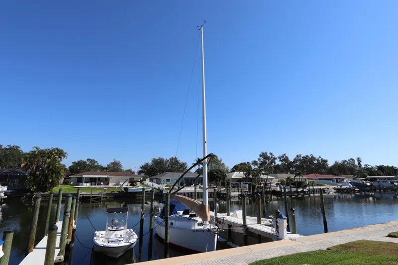 Slide: The Image of Sailboat docked in a marina, Nonsuch 260, 1995 model, under clear blue sky. - 3