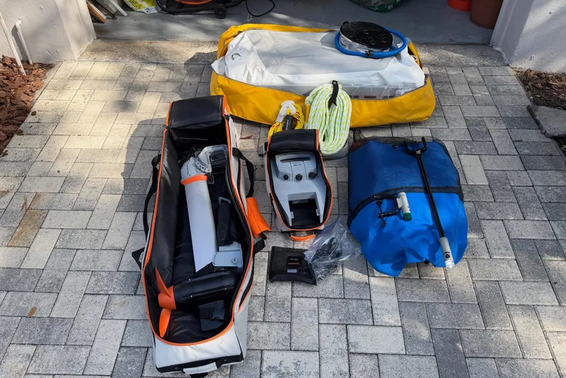 Slide: The Image of Sailing equipment and gear for a 1995 Nonsuch 260 displayed on a paved surface. - 41