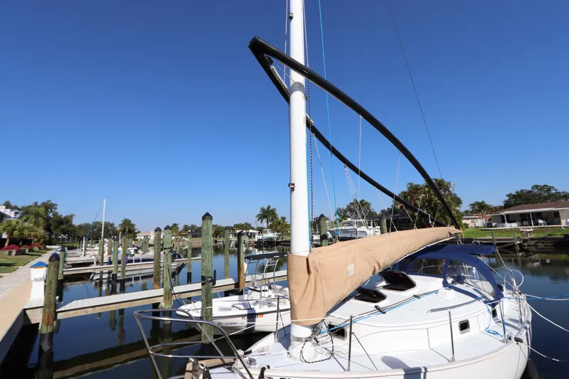 Slide: The Image of 1995 Nonsuch 260 sailboat docked at marina under clear blue sky. - 5