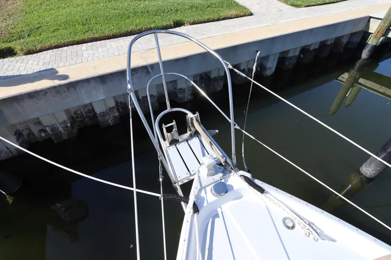 Slide: The Image of Bow of 1995 Nonsuch 260 sailboat docked by a concrete pier. - 8
