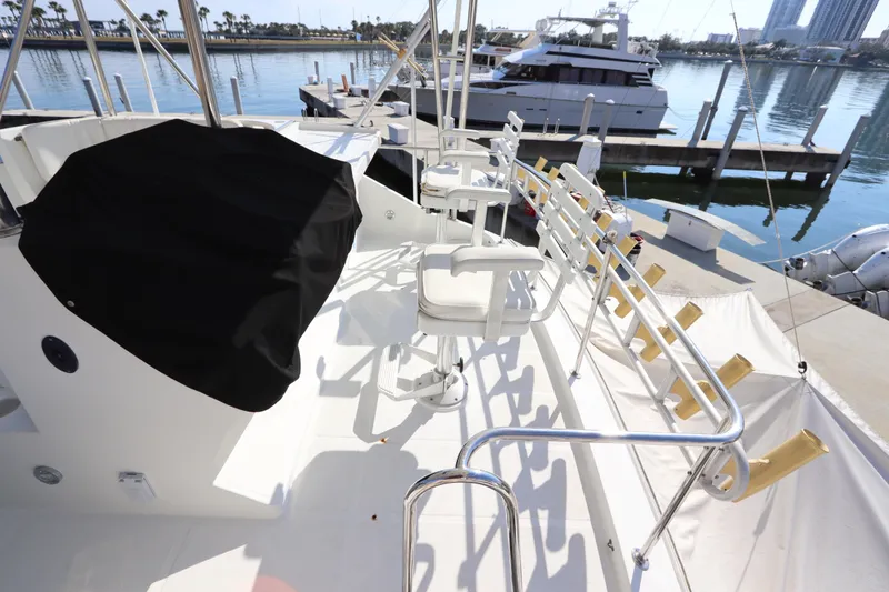 Slide: The Image of 1991 Spectrum 48 Convertible yacht deck with seating, docked at marina. - 11