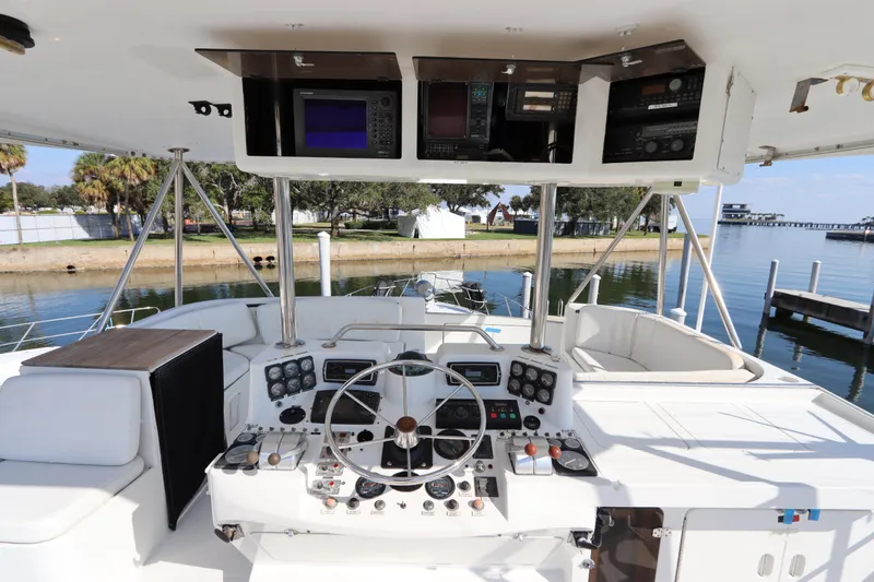 Slide: The Image of Cockpit of 1991 Spectrum 48 Convertible yacht with navigation equipment and steering wheel. - 12