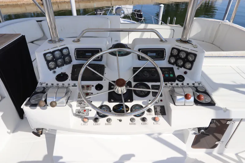 Slide: The Image of 1991 Spectrum 48 Convertible yacht helm with steering wheel and control panel. - 13