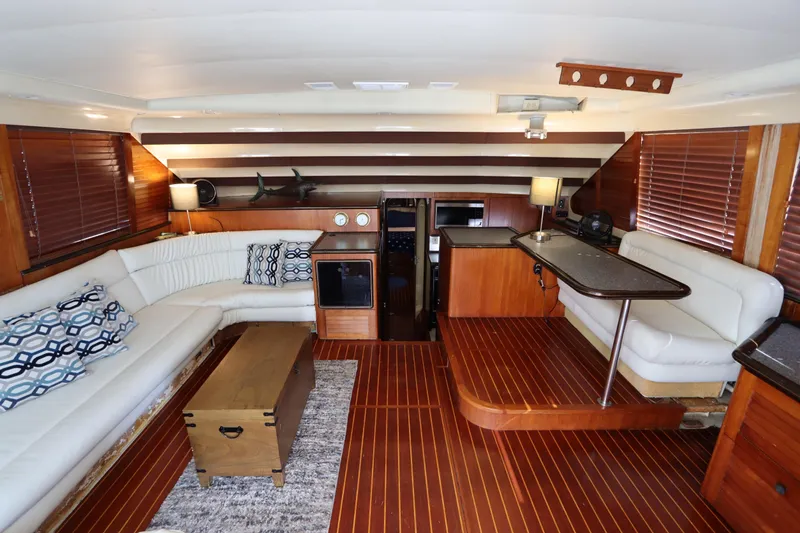Slide: The Image of Luxurious interior of 1991 Spectrum 48 Convertible yacht with elegant wood finishes and plush seating. - 14