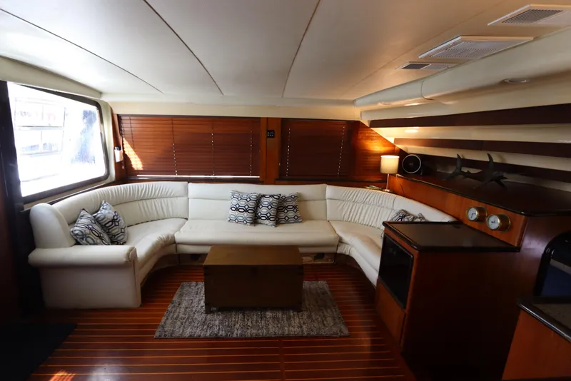 Slide: The Image of Luxurious interior of 1991 Spectrum 48 Convertible yacht with white leather seating and wooden accents. - 15