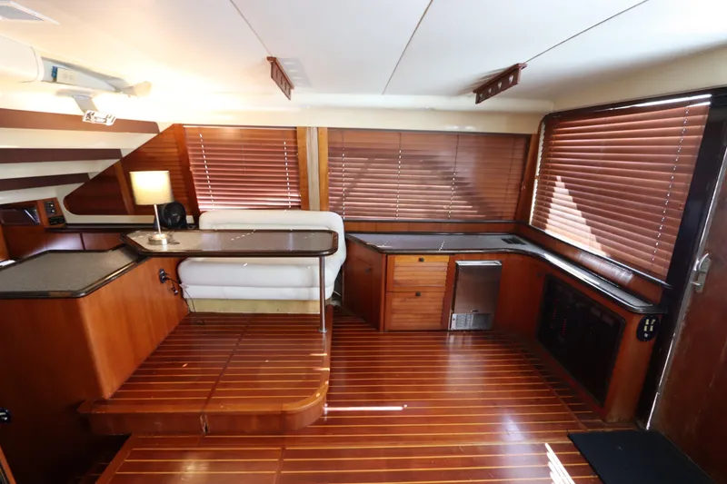 Slide: The Image of Luxurious 1991 Spectrum 48 Convertible yacht interior with wood finishes and modern amenities. - 16