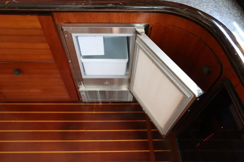 Slide: The Image of Open ice maker on 1991 Spectrum 48 Convertible yacht with wooden interior. - 18
