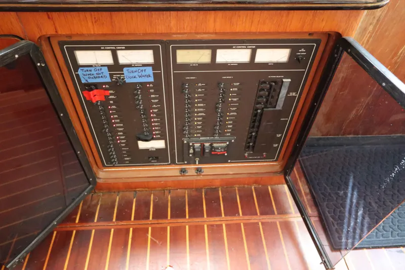 Slide: The Image of Electrical control panel on 1991 Spectrum 48 Convertible boat, featuring switches and meters. - 19