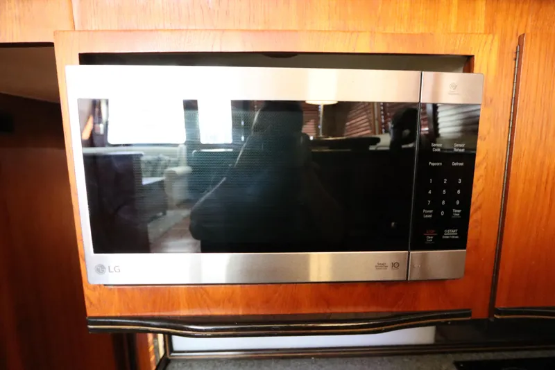 Slide: The Image of LG microwave in a 1991 Spectrum 48 Convertible kitchen setting. - 22