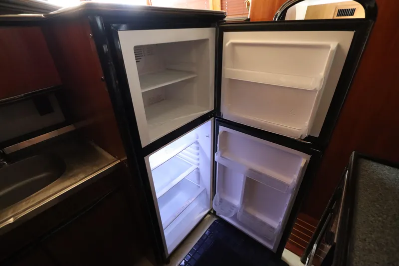Slide: The Image of Open refrigerator in 1991 Spectrum 48 Convertible yacht kitchen interior. - 26