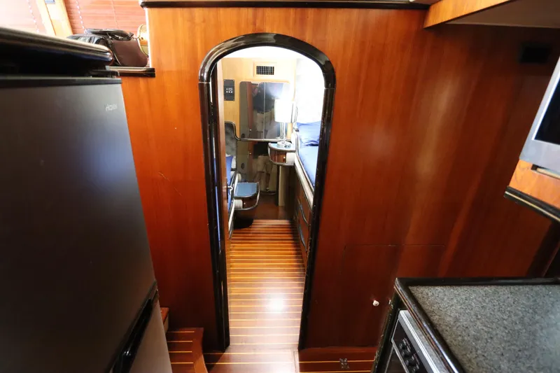 Slide: The Image of Interior view of 1991 Spectrum 48 Convertible yacht with wooden paneling and modern amenities. - 27