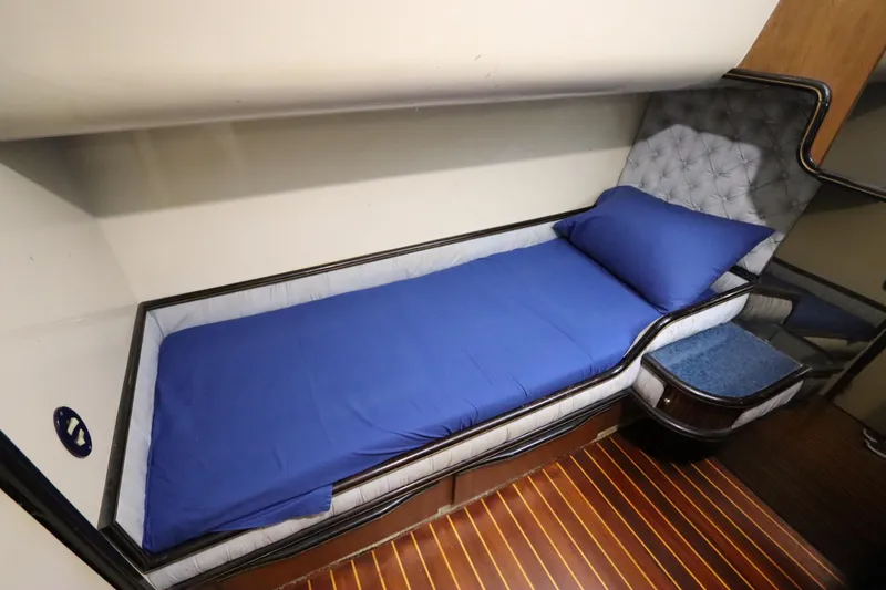 Slide: The Image of Luxurious cabin bed in 1991 Spectrum 48 Convertible yacht with blue bedding. - 28