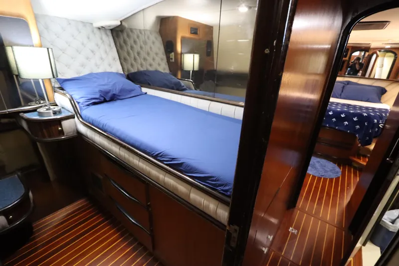Slide: The Image of Luxurious cabin interior of 1991 Spectrum 48 Convertible yacht with blue bedding. - 29
