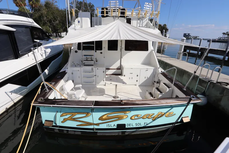 Slide: The Image of 1991 Spectrum 48 Convertible yacht docked, featuring spacious deck and canopy. - 3