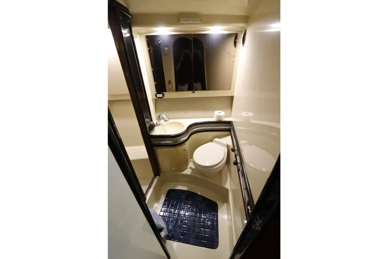 Slide: The Image of Compact bathroom in 1991 Spectrum 48 Convertible yacht with toilet, sink, and mirror. - 30