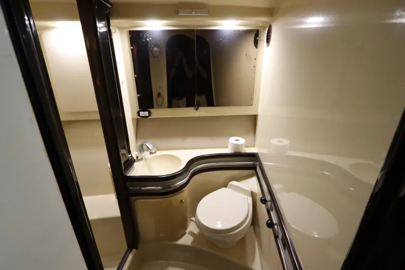 Slide: The Image of Bathroom interior of 1991 Spectrum 48 Convertible yacht, featuring sink, toilet, and mirror. - 31