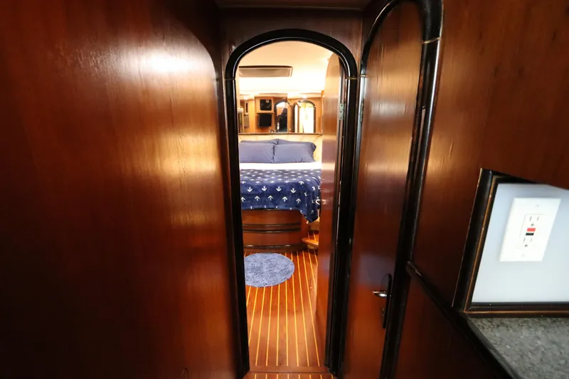 Slide: The Image of Interior view of 1991 Spectrum 48 Convertible yacht bedroom with wooden finish. - 34