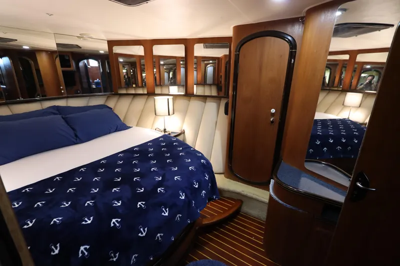 Slide: The Image of Luxurious cabin interior of 1991 Spectrum 48 Convertible yacht with nautical-themed bedding. - 35