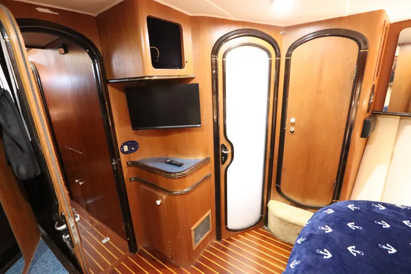 Slide: The Image of Interior of 1991 Spectrum 48 Convertible yacht with wood paneling and modern amenities. - 36