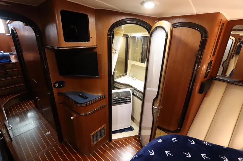 Slide: The Image of Interior of 1991 Spectrum 48 Convertible yacht with wood paneling and modern amenities. - 37