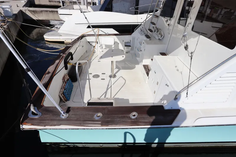 Slide: The Image of 1991 Spectrum 48 Convertible yacht with spacious deck and fishing equipment. - 4