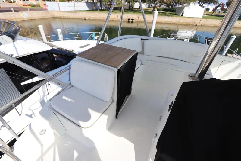 Slide: The Image of Luxurious seating area on a 1991 Spectrum 48 Convertible yacht, docked by the water. - 9