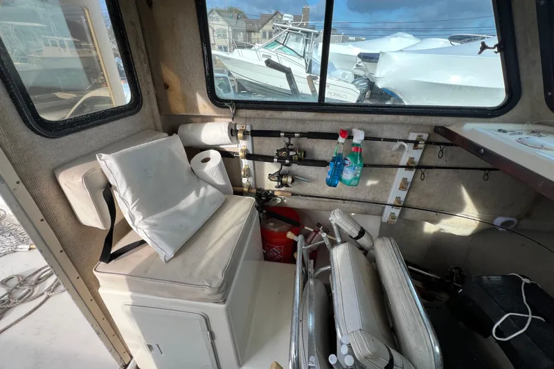 Slide: The Image of Interior of 2001 Parker 2520 Deep Vee Sport Cabin with fishing gear and seating. - 11