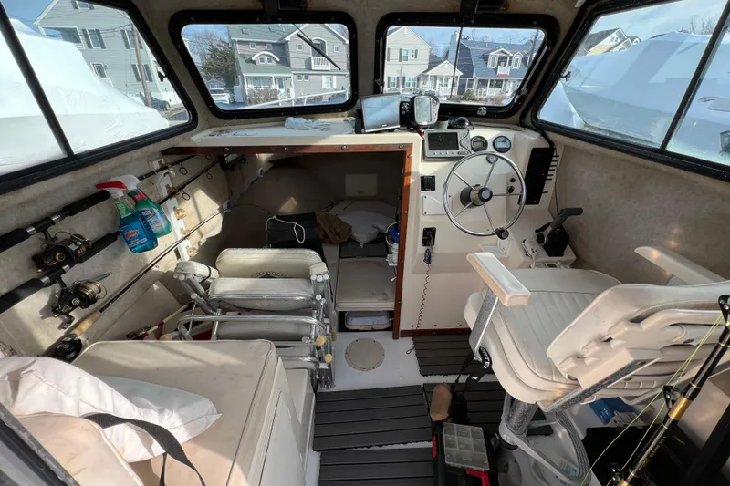Slide: The Image of Interior of a 2001 Parker 2520 Deep Vee Sport Cabin boat with fishing gear. - 13