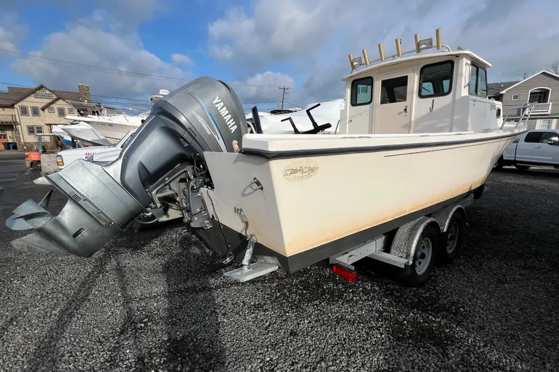 Slide: The Image of 2001 Parker 2520 Deep Vee Sport Cabin boat with Yamaha outboard motor on trailer. - 3