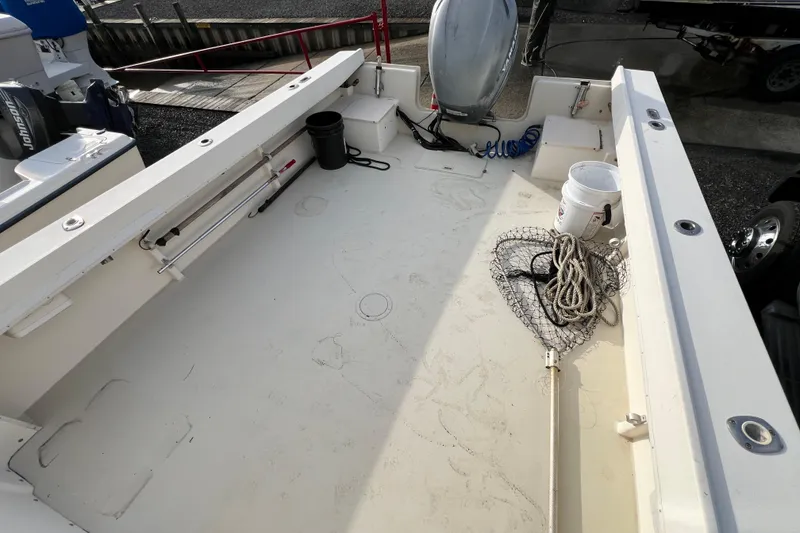 Slide: The Image of 2001 Parker 2520 Deep Vee Sport Cabin boat deck with fishing gear and equipment. - 5