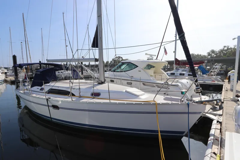 The Image of 2011 Catalina 355 sailboat docked at a marina, surrounded by other boats. - 0